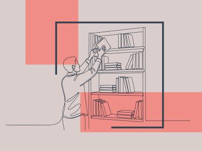 En fyr står ved en bogreol og trækker en bog ud fra øverste hylde.